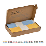 Geöffnete Geschenkbox mit Diamond-Foutas in Senfgelb und Hellblau